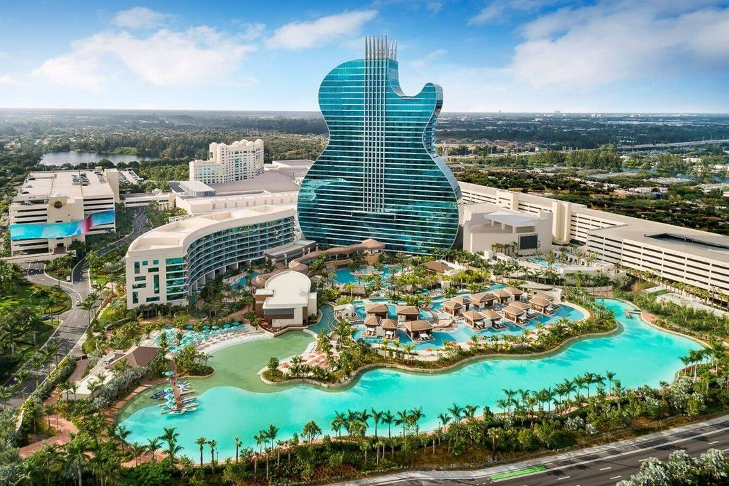 Hotel building shaped like a guitar in a tropical setting